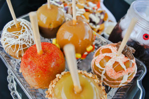 Caramel apples rolled in Halloween candy